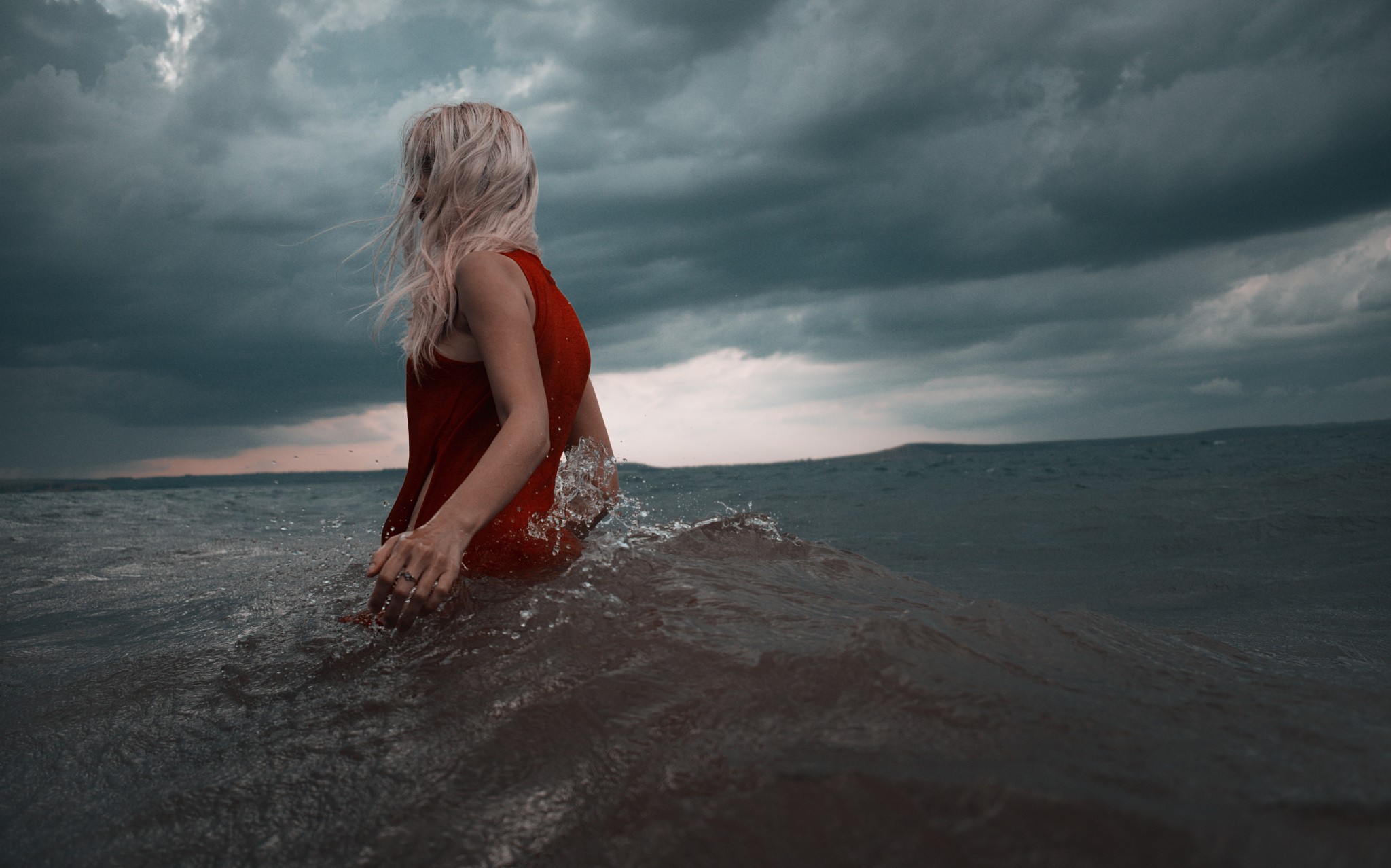 Women Blonde Windy Waves Clouds Storm Rear View Red Clothing Wet Roman Filippov 2048x1278