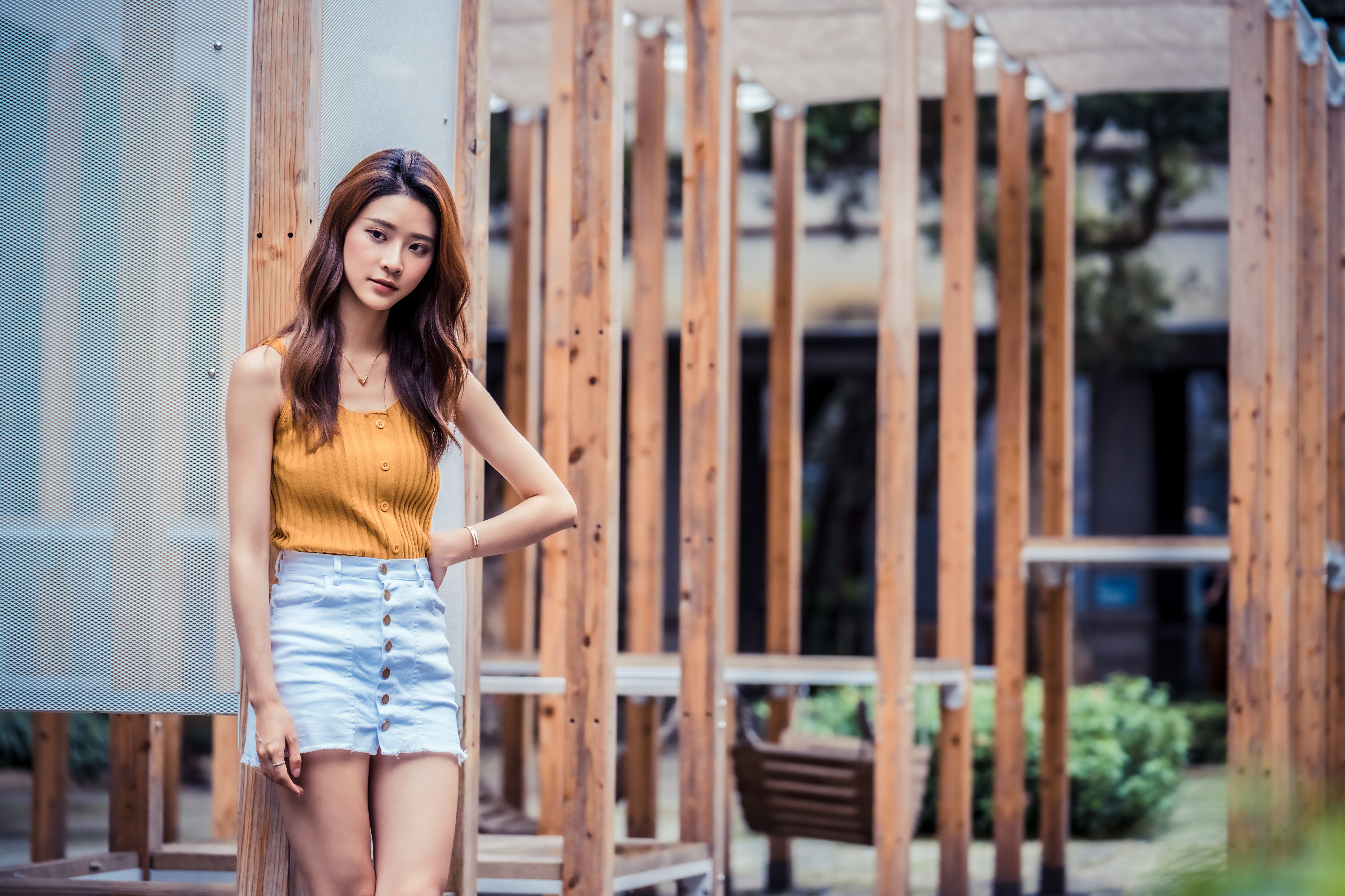 Asian Model Women Long Hair Brunette Jeans Skirt Yellow Shirt Depth Of Field Plants Leaning Bracelet 3840x2559