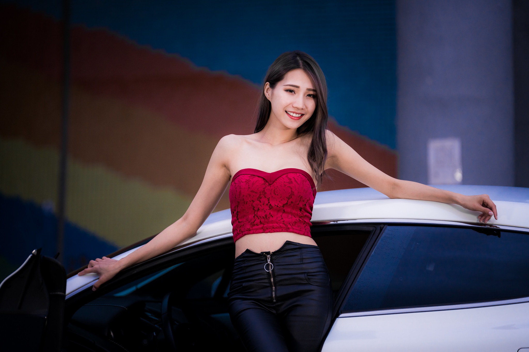 Asian Model Women Long Hair Brunette Red Tops Black Pants Car Leaning Bare Shoulders Zipper Smiling 2048x1365
