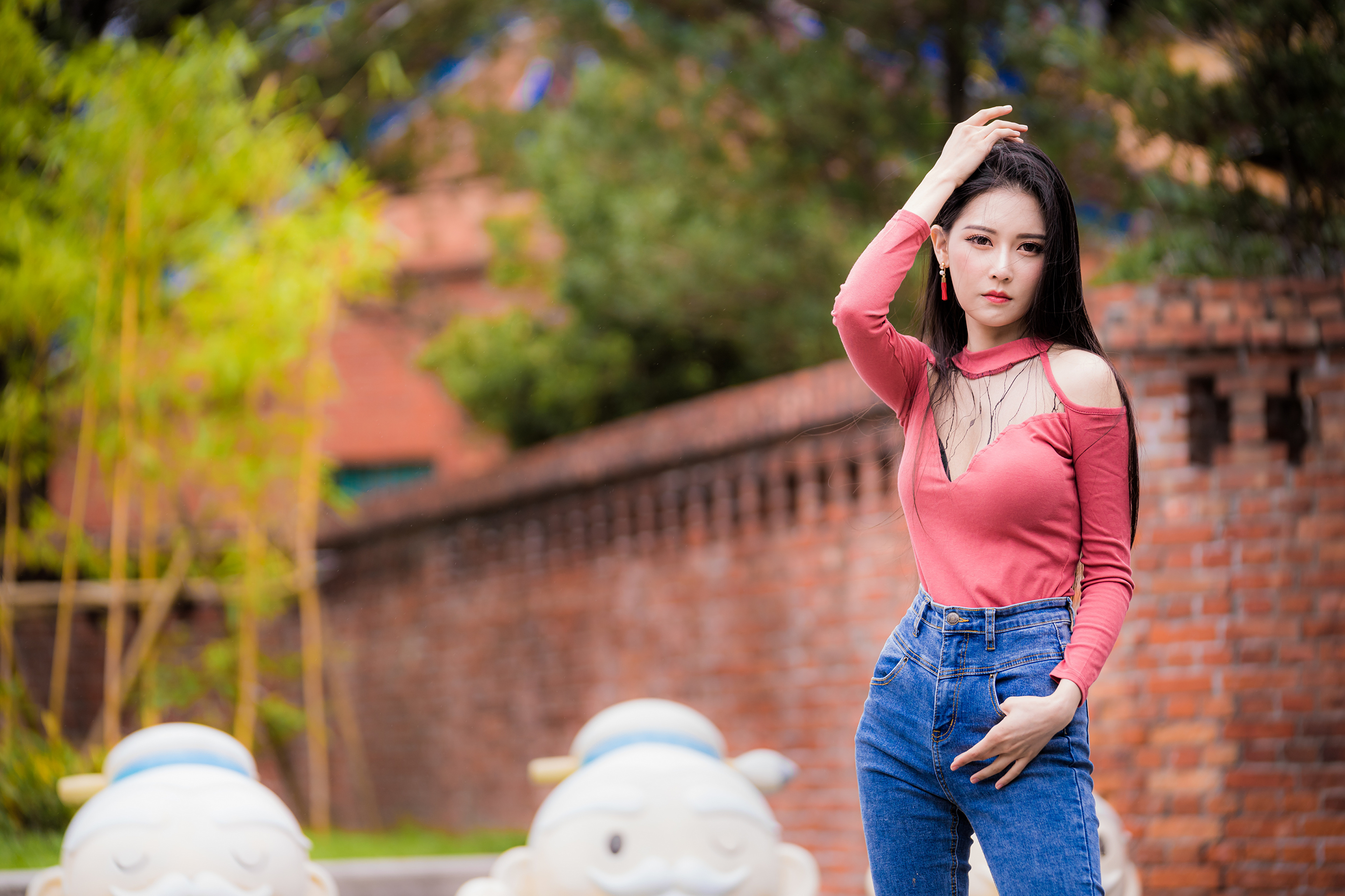 Asian Model Women Depth Of Field Long Hair Dark Hair Jeans Red Shirt Trees Wall Bricks Earrings 3840x2559