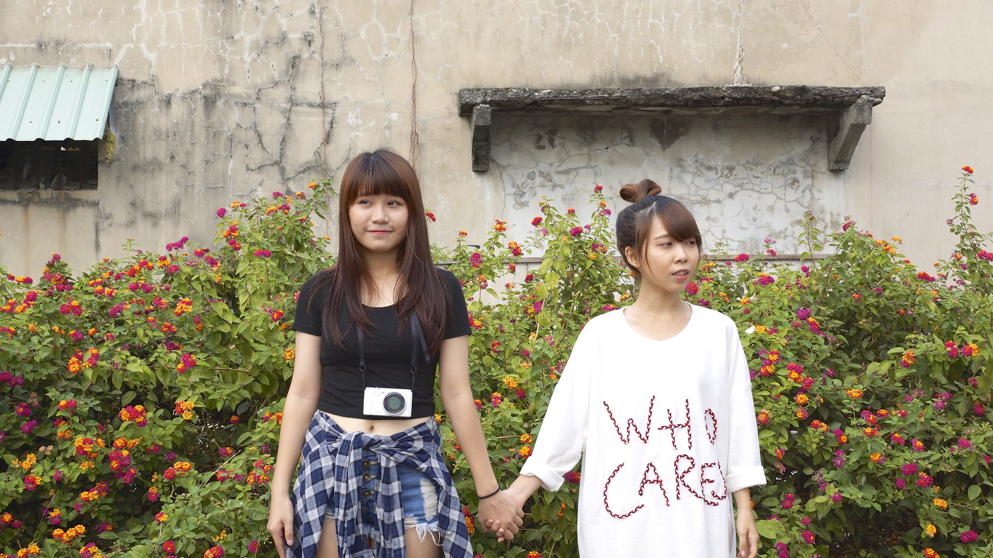 Asian Women Model Two Women Women Outdoors Urban Holding Hands Camera Shirt Black Top Plants Looking 2047x1152