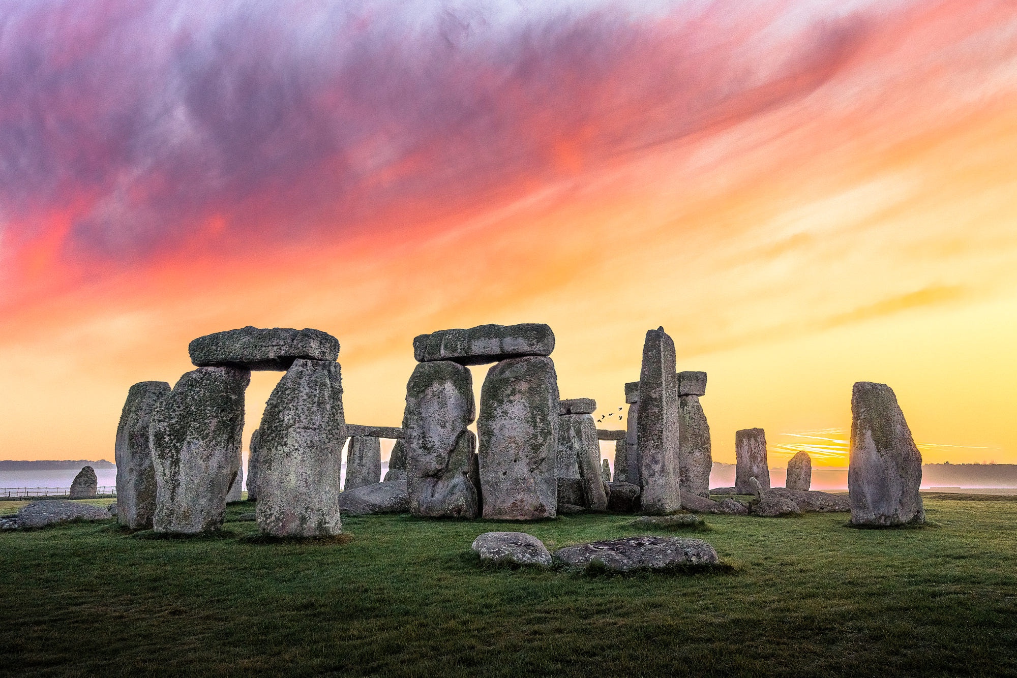 Stonehenge Prehistoric Sunset Glow Rocks Grass Sky Clouds 2000x1334