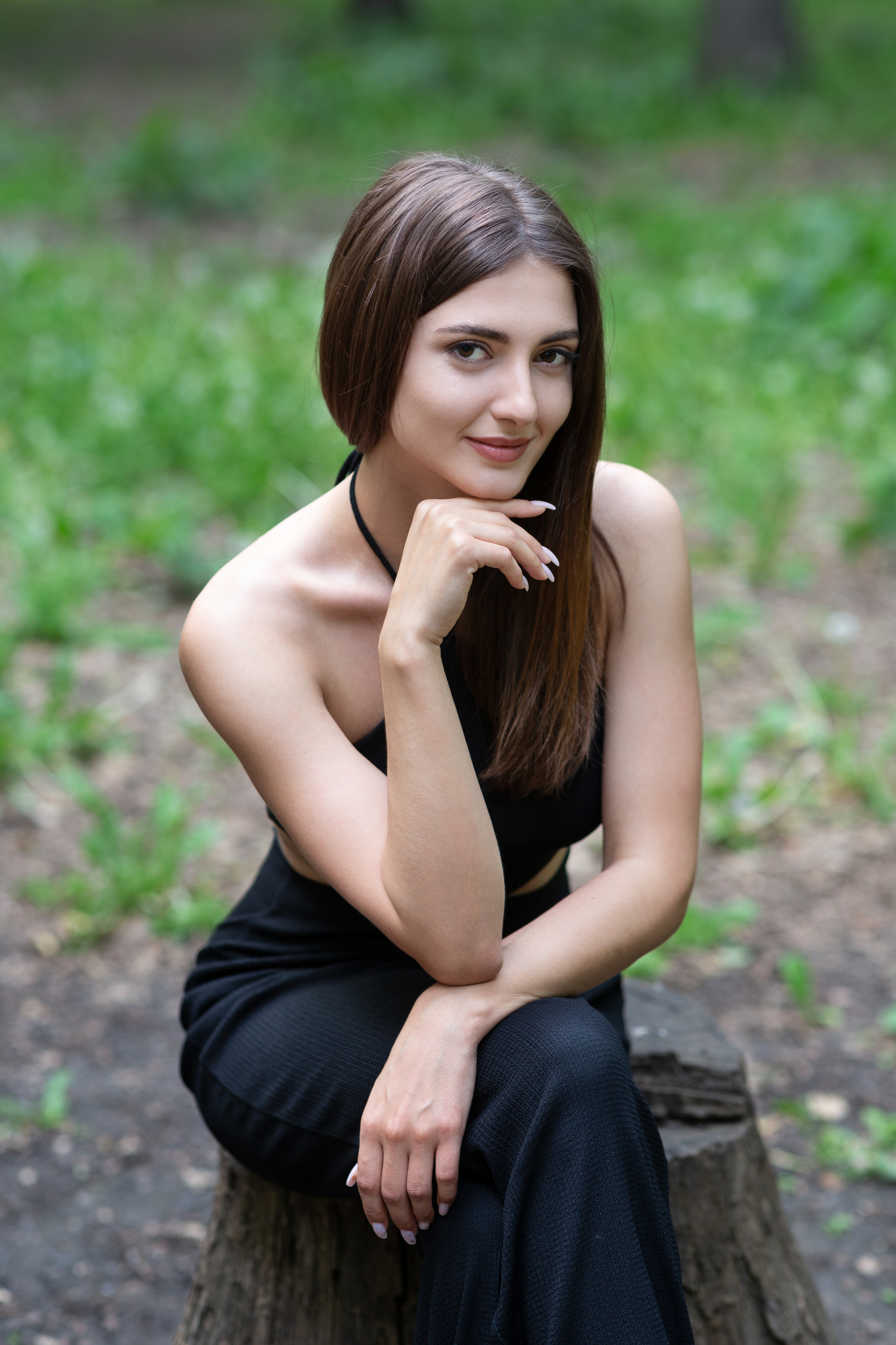 Murat Kuzhakhmetov Women Brunette Long Hair Smiling Black Clothing Legs Crossed Tree Stump 2333x3500