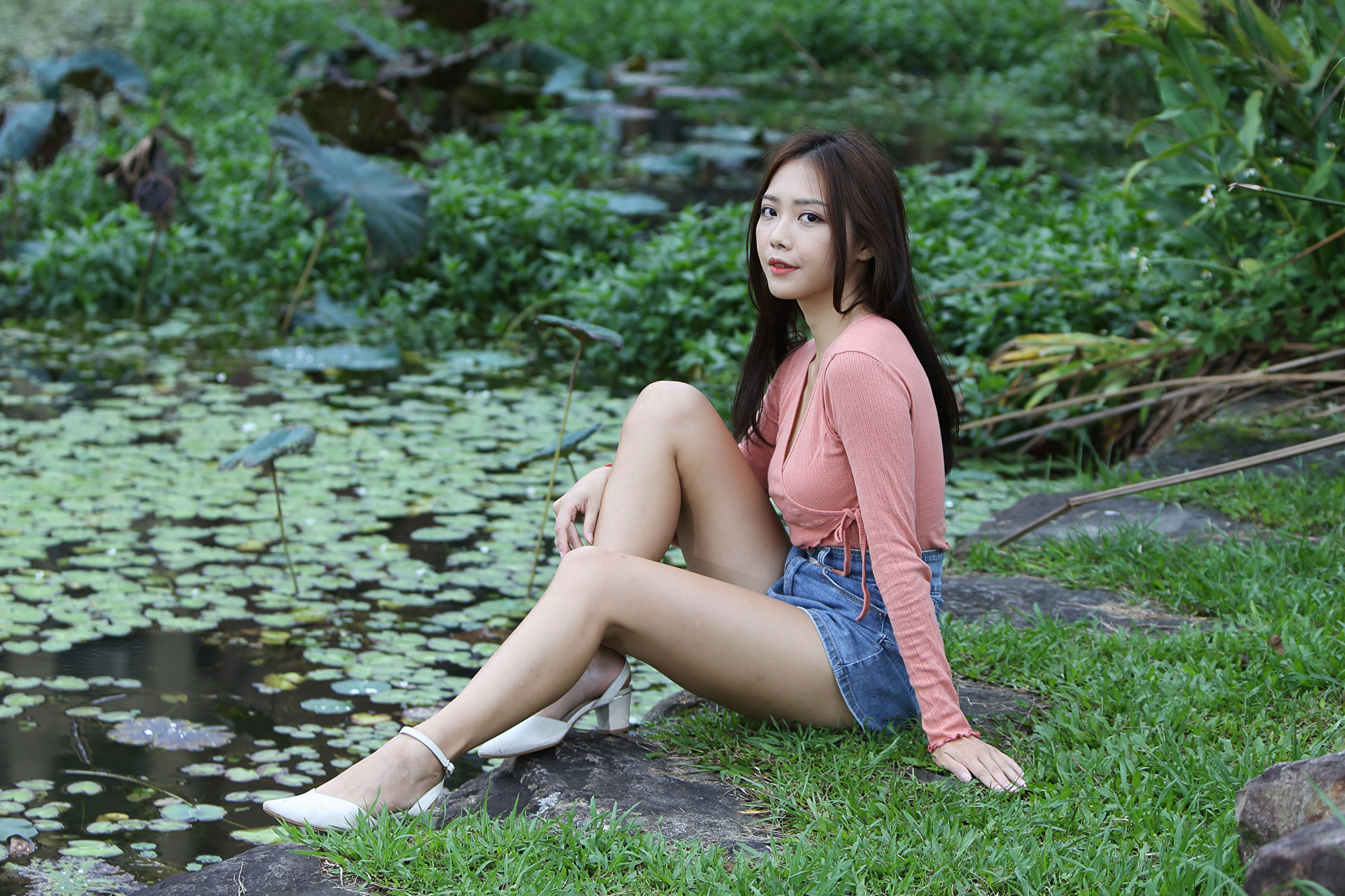 Asian Model Women Long Hair Dark Hair Sitting Jean Shorts Grass Depth Of Field Pond White Shoes Long 2560x1706