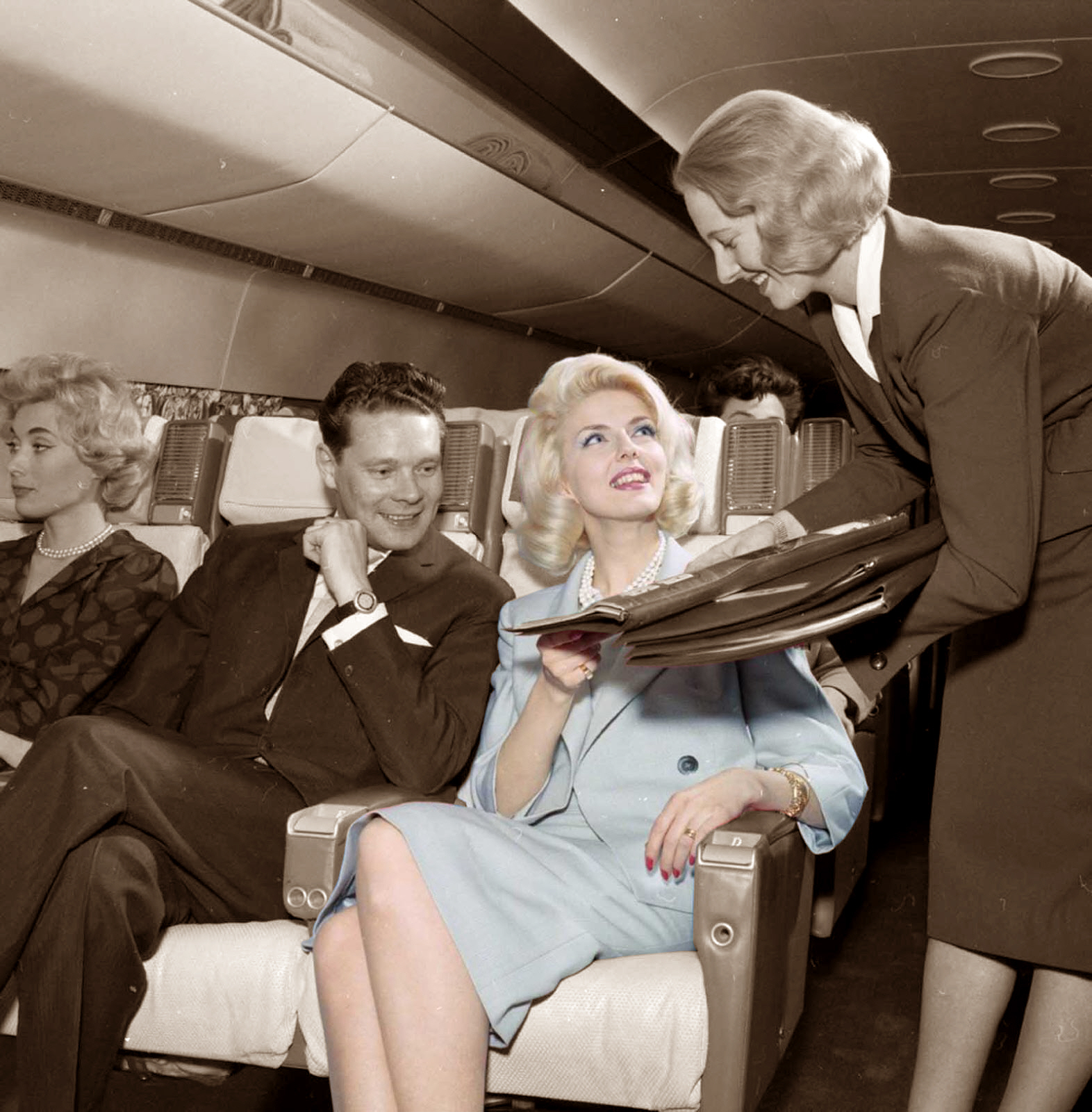 Women Airplane Interior Legs Crossed Men Smiling 1572x1600