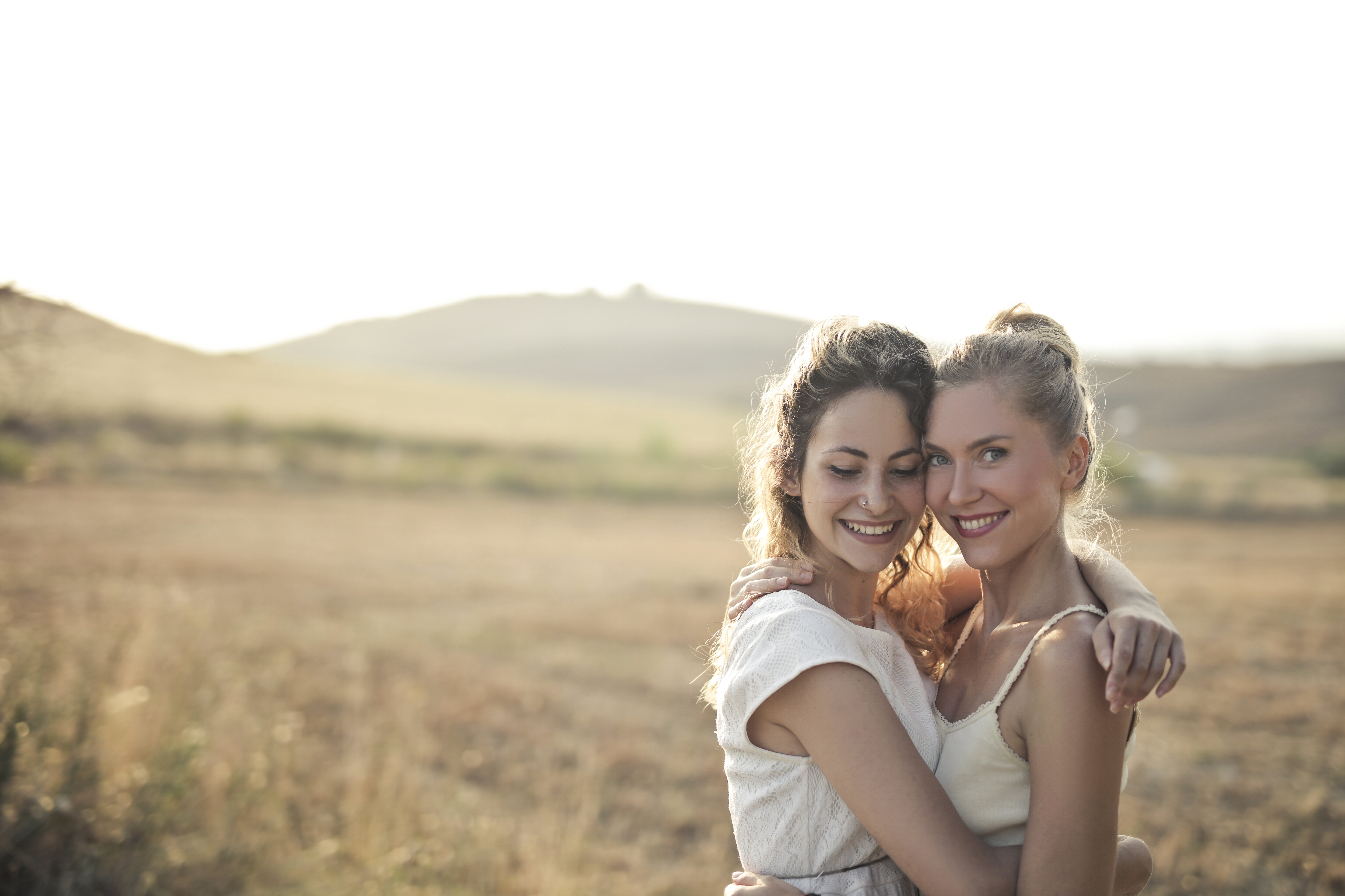 Women Two Women Outdoors Smiling Hugging White Clothing Field Model Brunette Blonde Nose Ring Women  7680x5120