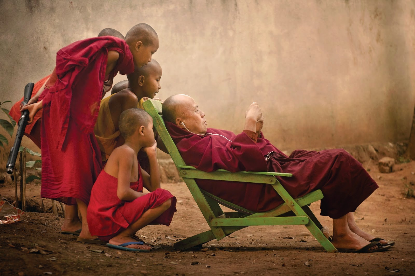 Men Outdoors Group Of People Monks Malaysia Children Earphones Flip Flops Bald Head Sitting 1600x1064
