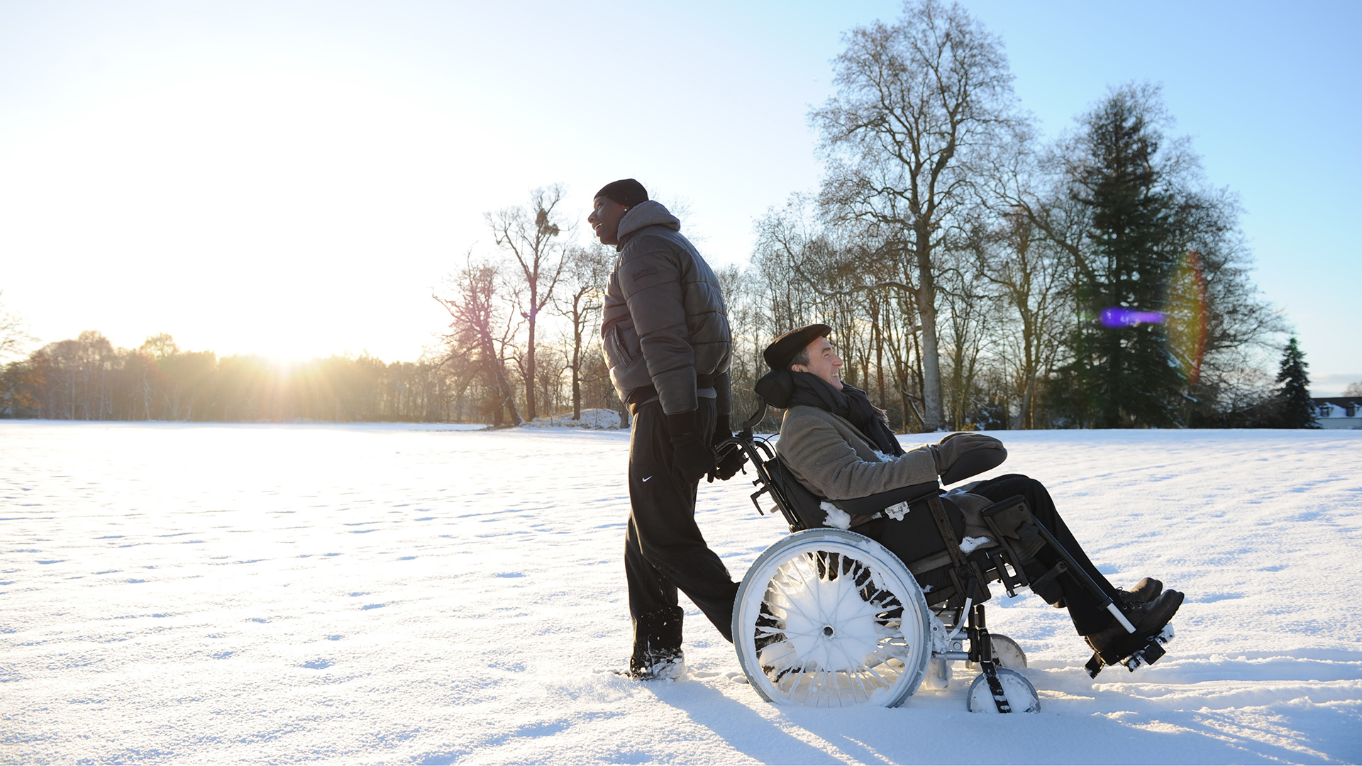 Omar Sy Driss The Intouchables Francois Cluzet Philippe The Intouchables Wheelchair Smile Snow Sunri 1920x1080