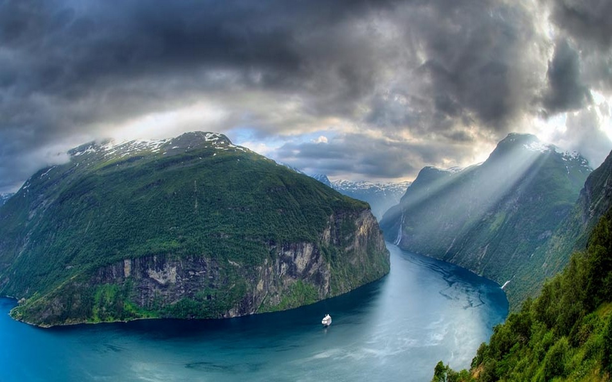 Nature Landscape Geiranger Fjord Norway Sun Rays Mountains Clouds Cruise Ship Cliff Snowy Peak 1230x768