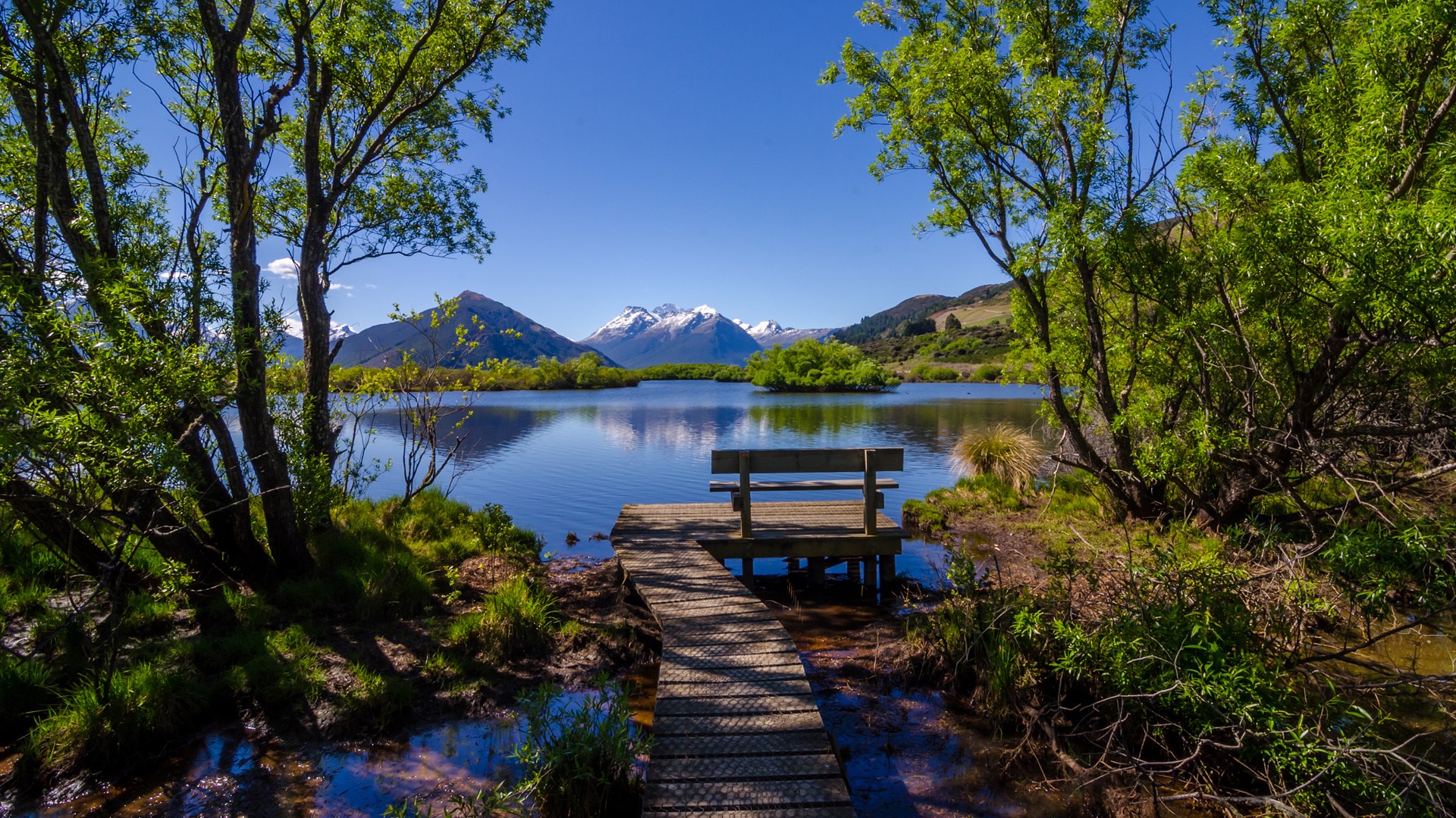 Lake Landscape Bench Path Trees Snowy Mountain Clear Sky Water Water Ripples Plants Grass Clouds Wal 1920x1080