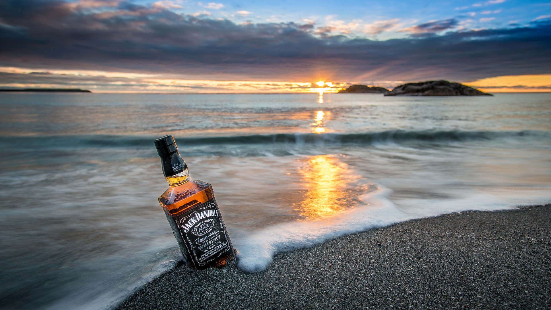 Nature Landscape Sea Coast Bottles Whiskey Jack Daniels Sunrise Waves Clouds Rock Island Beach Sand  1920x1080