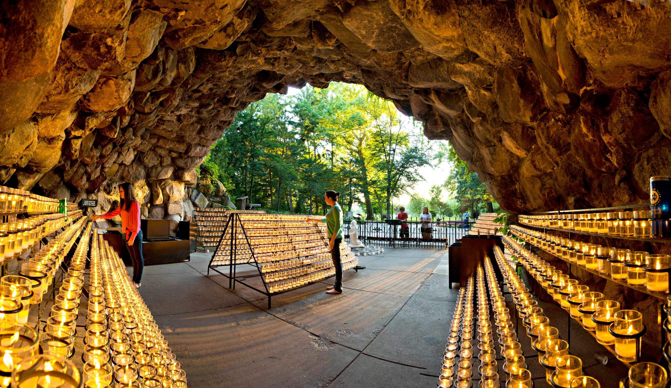 Religious Candles Outdoors People Cave Stone Arch Warm Colors Brown 2686x1553