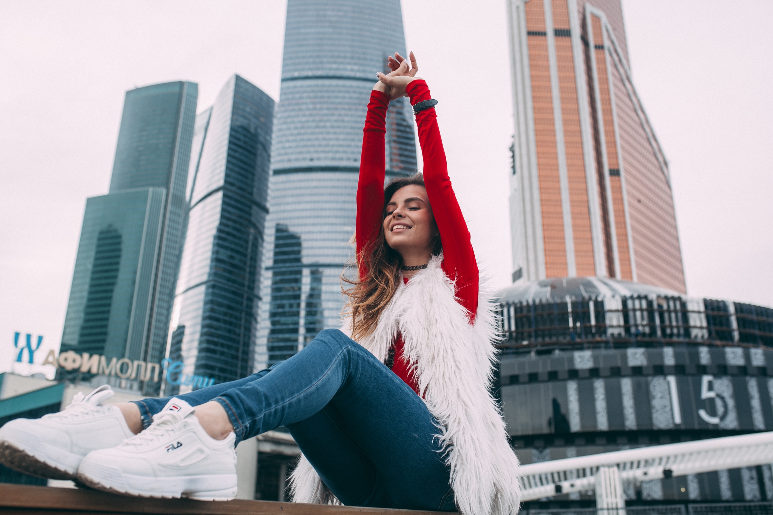 Women Model Brunette Smiling Necklace Red Tops Fur Coats Jeans Denim Sneakers Fila Sitting Arms Up W 2560x1707
