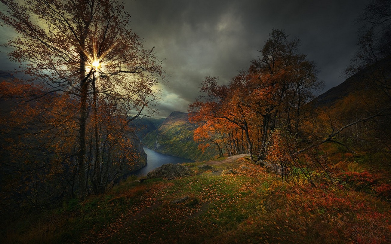 Nature Landscape Photography Geiranger Fjord Fall Sun Rays Canyon Dark Clouds Trees Shrubs Sunlight  1300x812