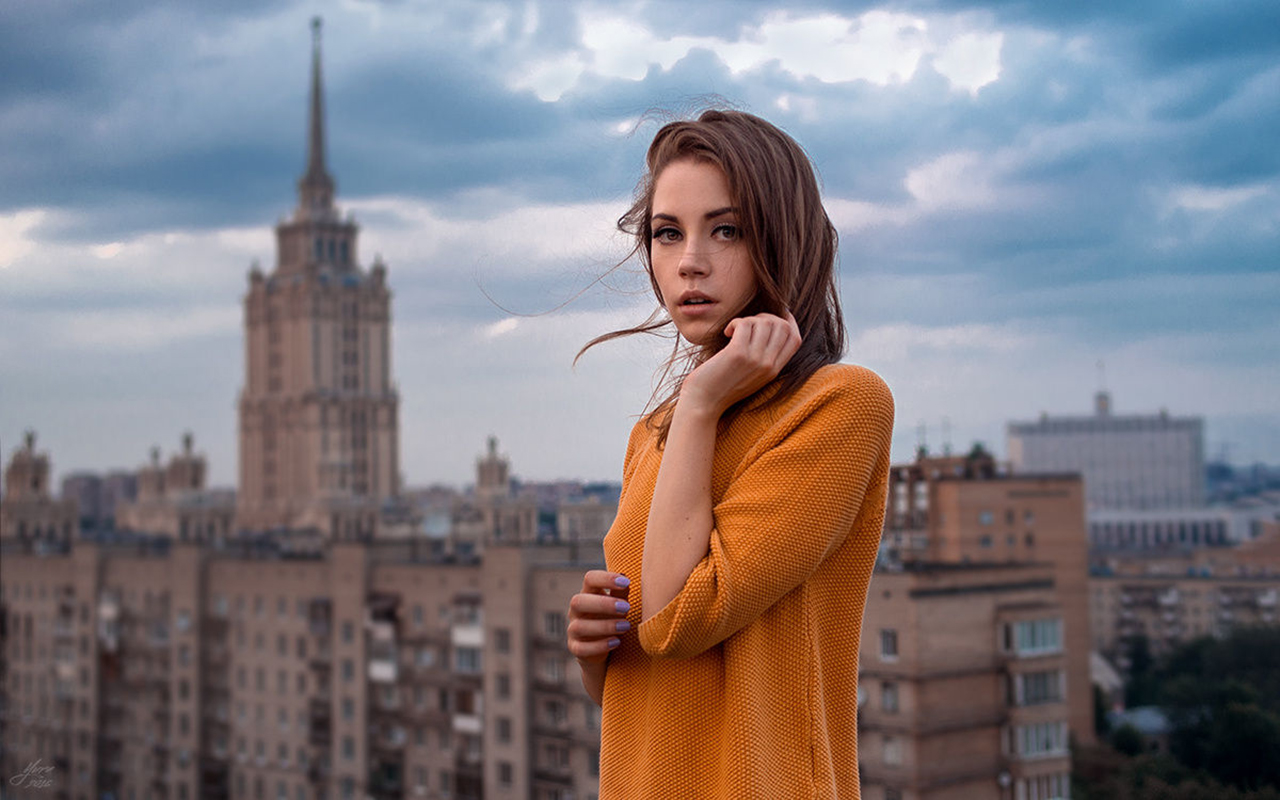 Ksenia Kokoreva Women Brunette Long Hair Straight Hair Hands In Hair Orange Sweater City Sky Clouds  1280x800