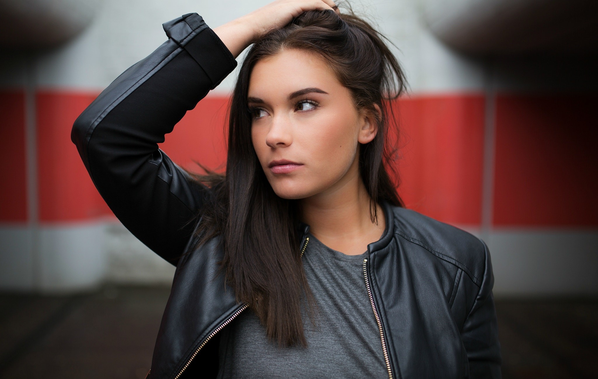 DAVALi Photography Arms Up 500px Women Model Leather Jackets Brunette Hands On Head Grey Tops Brown  2048x1299