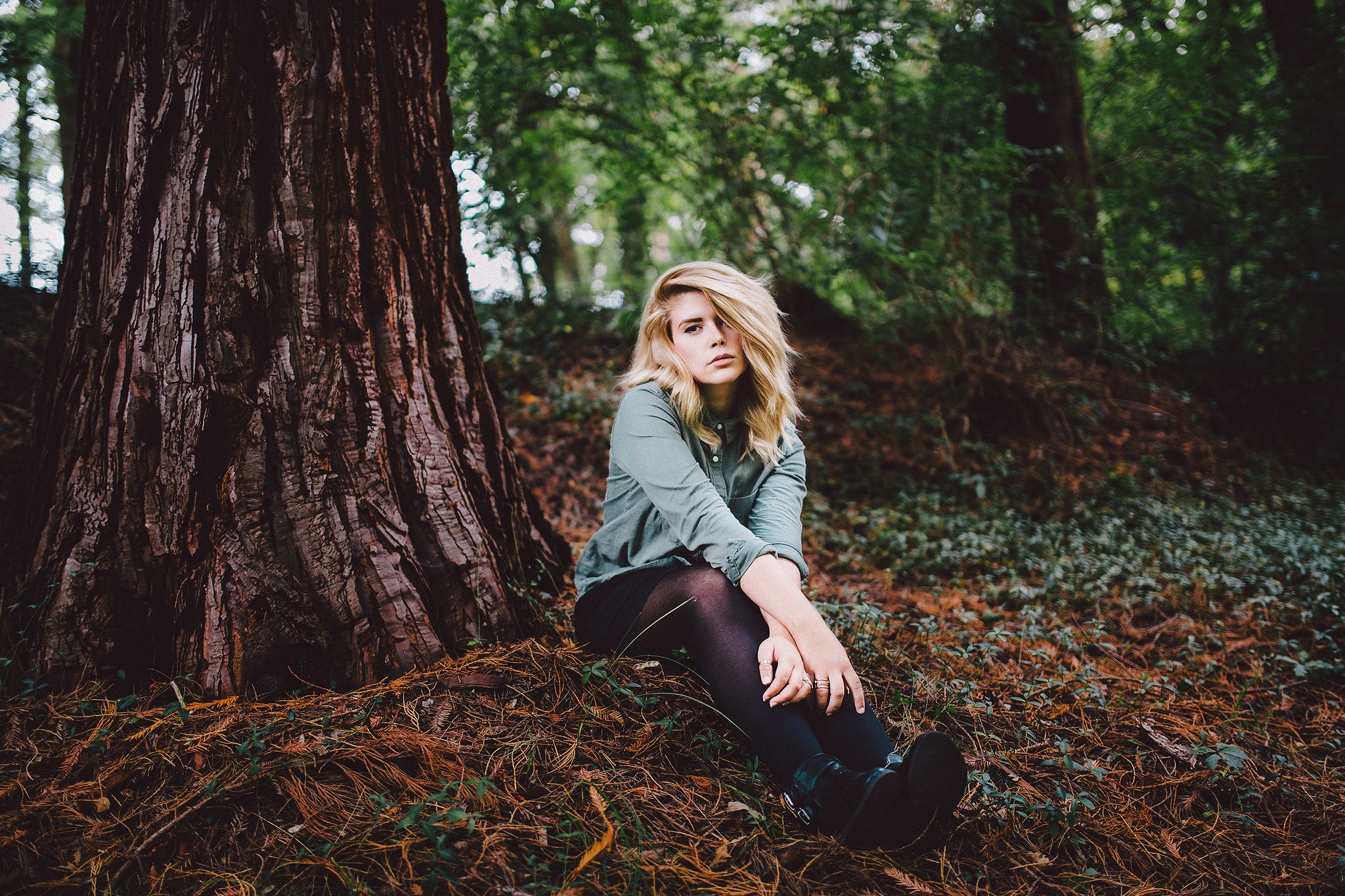 Women Blonde Hair In Face Sitting Forest Women Outdoors Hands On Legs Looking Away 2048x1365