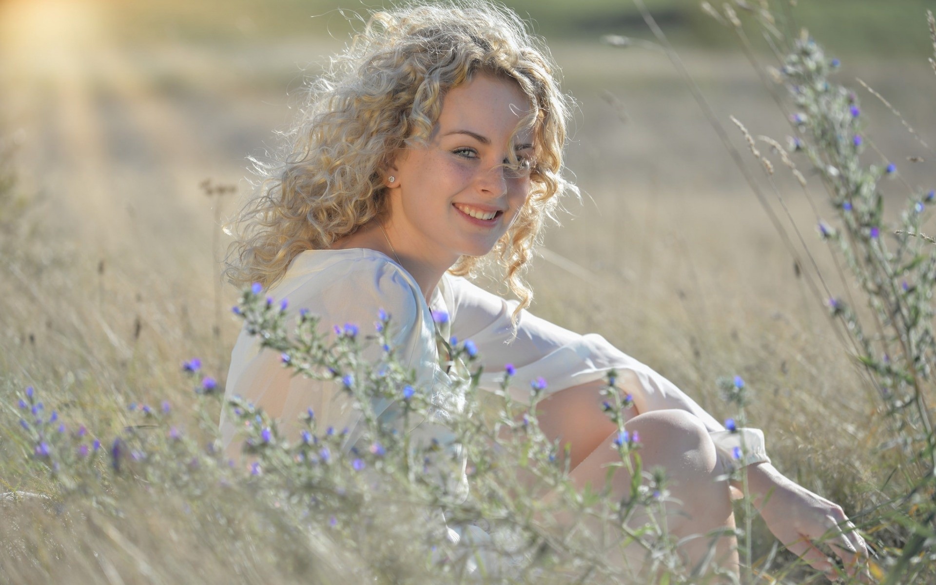 Women Model Blonde Long Hair Smiling Women Outdoors Blouses Curly Hair Field Sitting Face Plants Sun 1920x1200